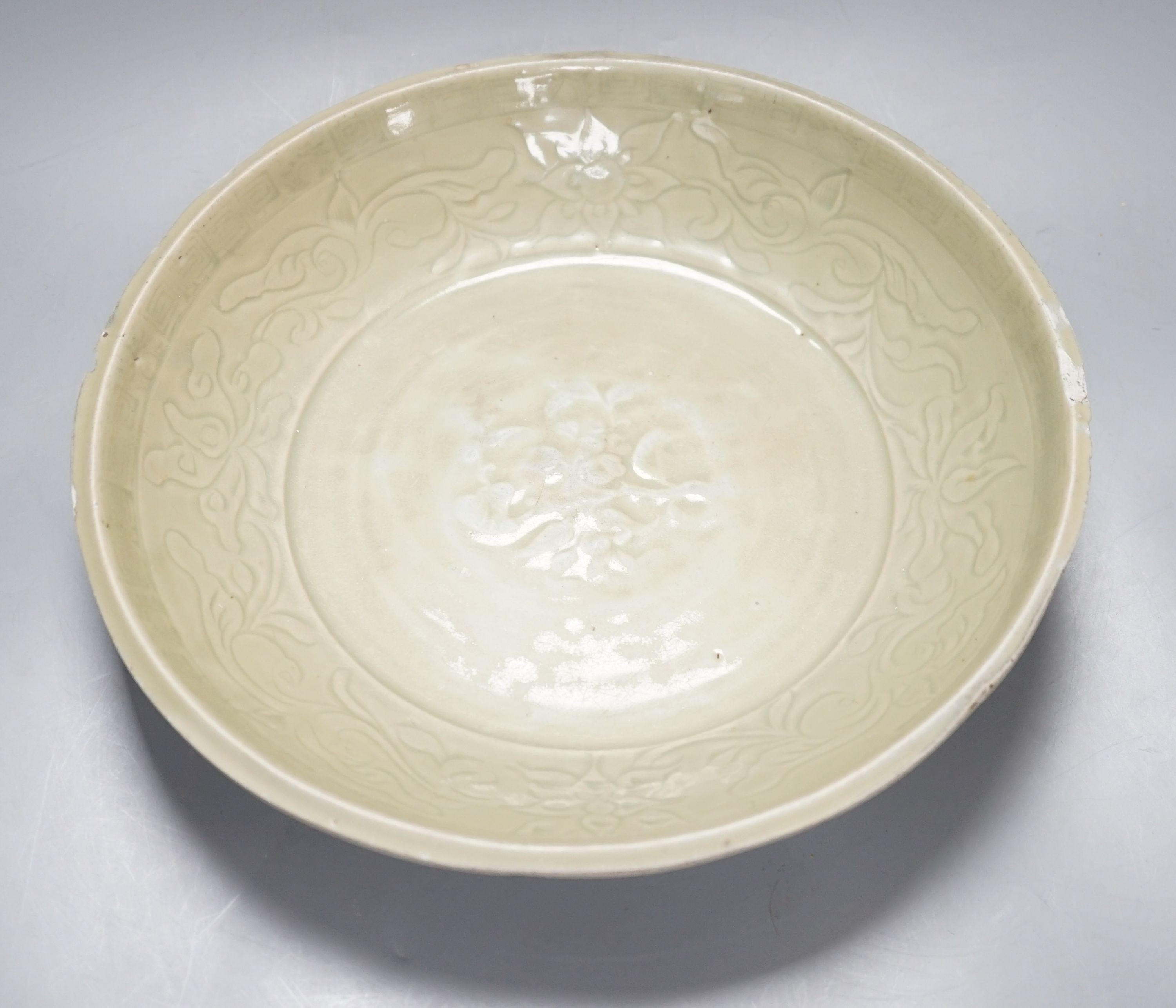 A Chinese Ming Longquan celadon dish, 15th/16th century, rim cut down, width 33cm